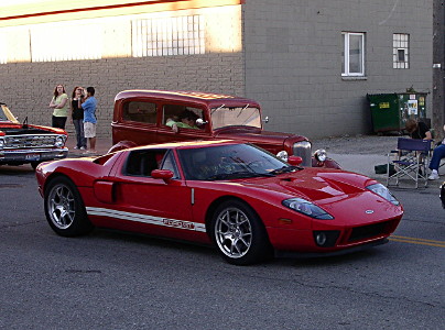 [A red Corvette-looking vehicle with a white stripe along the bottom side panel.]